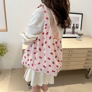 Pink corduroy tote bag with red strawberry print and integrated shoulder strap