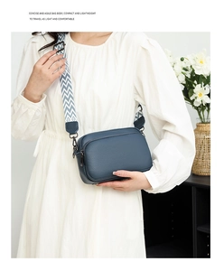 Detailed view of blue litchi grain leather crossbody bag with geometric wide strap
