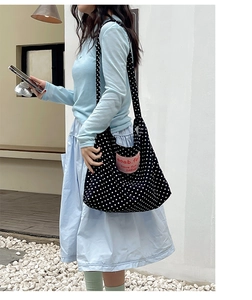 Polka dot canvas tote bag showing large capacity and pink logo patch detail