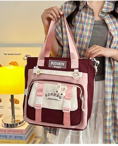 Detail of multi-color nylon crossbody bag with cute bunny brooch and embroidery