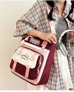 Detail of contrast nylon crossbody bag with bunny charm and adjustable strap worn by model