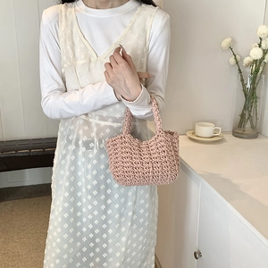 Elegante borsa a secchiello rosa all'uncinetto da donna con stile minimalista e trama tessuta
