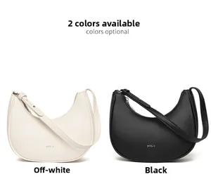 Detail view of smooth lychee grain leather texture and metallic logo on the hobo bag