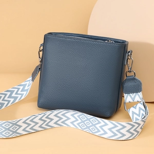 Genuine leather crossbody bucket bag in dark blue with stylish wide geometric shoulder strap