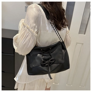 Black PU leather tote bag with drawstring lace-up design and silver chain shoulder strap