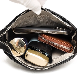 Top view of black leather bucket bag interior capacity with smartphone and wallet
