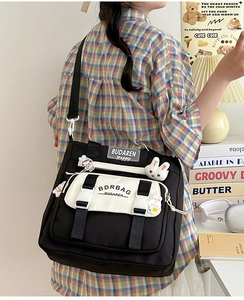 Detailed view of nylon crossbody bag with black contrast trim and adjustable strap