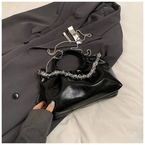 Fashionable black glossy PU leather handbag with metal chain handles and shoulder strap