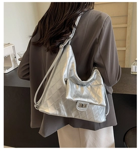 Silver PU hobo bag with quilted rhombus pattern and metal twist lock on model