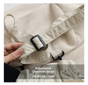 Detail of adjustable oxford cloth shoulder strap with black buckle and swivel hook