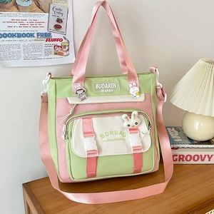 Pink and green nylon crossbody bag with cute badges and wide shoulder strap