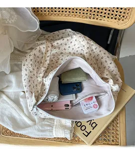 Spacious floral canvas tote bag interior with zipper pocket on a vintage chair
