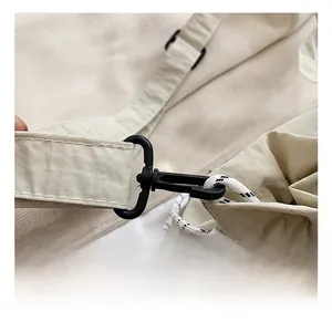 Detail shot of a beige Oxford fabric crossbody bag with high-quality plastic hook and drawstring