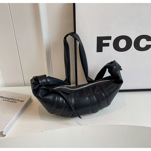 Minimalist black PU crescent shoulder bag with quilted texture and knotted strap design