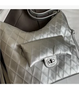 Close-up of quilted silver PU leather tote bag with metallic finish and turn-lock closure