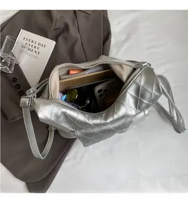 Top view of silver quilted shoulder bag interior showing spacious storage for daily items