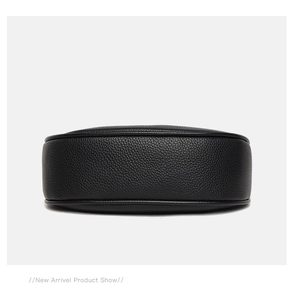 Close-up of the black pebble leather bottom and detailed stitching on the underarm bag