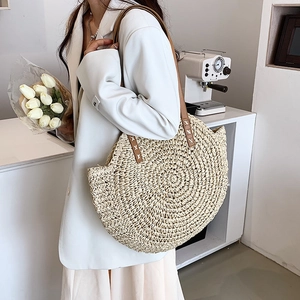 Large straw tote bag with brown leather straps for summer beach holidays and daily commute