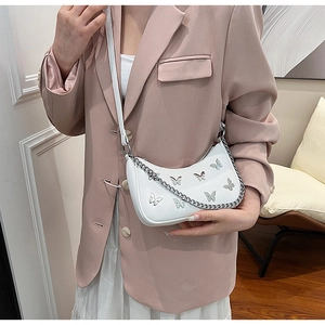 Détail du sac à bandoulière blanc en similicuir avec motif papillon argenté élégant