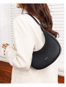 Detail showing high-quality black litchi leather texture and silver STLY logo on bag