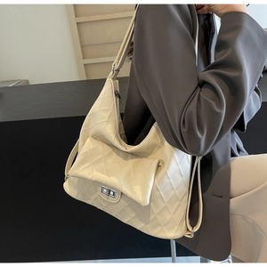 Detailed view of cream beige quilted PU leather shoulder bag with silver turn-lock pocket