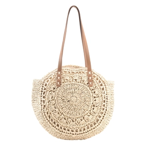 Detailed macro view of concentric woven circular pattern on beige straw tote bag