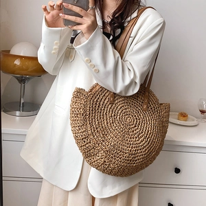 Large half-round straw shoulder bag with brown leather straps for summer vacations