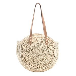 Large circular straw tote bag with brown leather handles for summer beach vacation use
