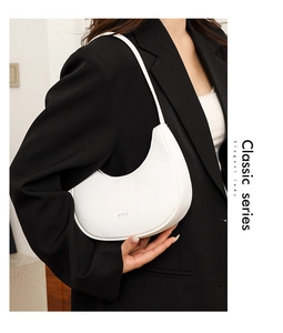 Detailed close-up of white lychee-textured leather hobo bag with silver STLY logo