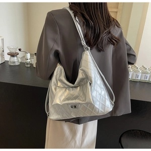 Detailed side view of silver quilted PU leather shoulder bag with a metal twist lock