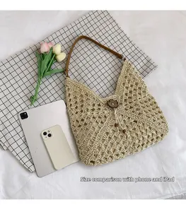 Detail of straw shoulder bag with flower wooden buckle showing iPad and phone size comparison