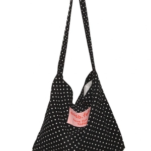 Retro black and white polka dot canvas hobo bag with pink logo patch for women