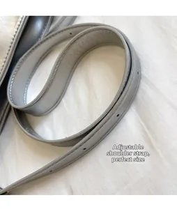 Close-up of an adjustable grey PU leather shoulder strap with visible stitching