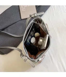 Top view of metallic silver PU crossbody bag showing spacious interior with multiple pockets