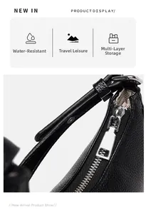 Detail of waterproof black lychee leather bag with silver zipper and multi-layer storage