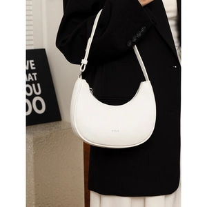 Minimalist white crescent underarm bag with lychee texture leather on fashion model