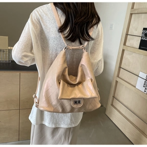 Close-up detail of beige quilted PU leather shoulder bag with metallic buckle