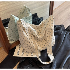 Minimalist cream floral canvas tote bag with wide shoulder strap and zipper closure