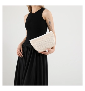 Detail showing the woven texture and white zipper of this stylish beige PU handbag