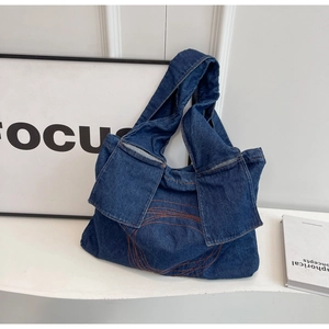 Minimalist navy denim tote bag with orange circular patterns and unique strap pockets