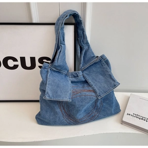 Minimalist blue denim tote bag with circular embroidery and a retro casual design