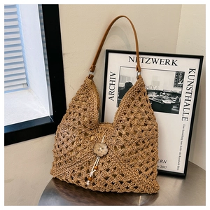 Chic woven straw shoulder bag with wooden flower detail and smooth leather straps
