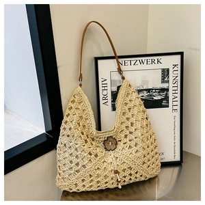 Chic beige woven straw tote bag with brown leather straps and floral wooden clasp detail