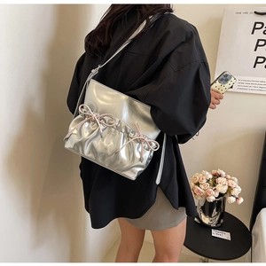 Silver metallic PU leather shoulder bag featuring a decorative pink ribbon bow detail