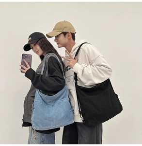 Detail view of denim and black canvas backpacks with wide straps and side pockets