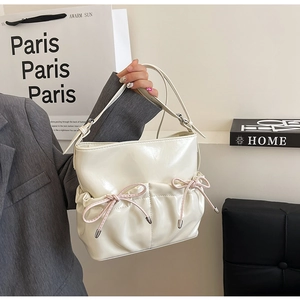 Chic white PU crossbody bag with pink bow accents and glossy finish for spring