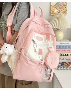 Pink and white nylon backpack with a cute bear plush charm and round mini coin pouch