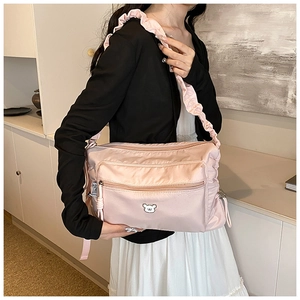 Pink nylon crossbody bag detail with cute bear emblem and pleated ruffle strap design