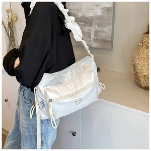 Detail of white nylon pleated shoulder bag with bear graphic and adjustable drawstring