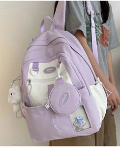 Detail of lavender nylon backpack with cute cat plush and clear star glitter pocket